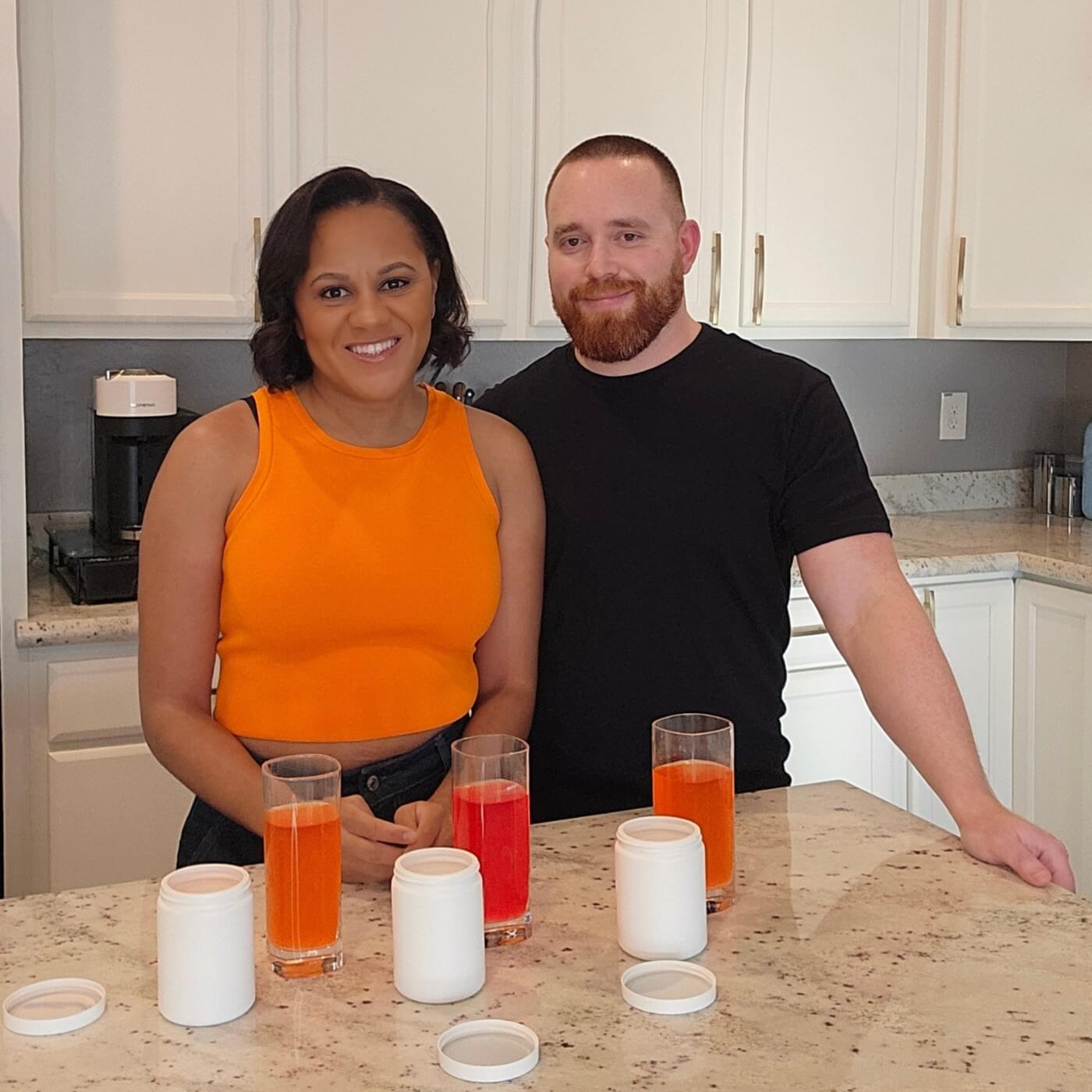 Kamren and Mike, founders of Yumsentials, standing in a kitchen with drink samples